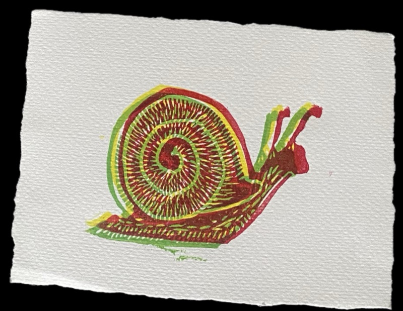 Linocut print of a snail in red, green and yellow